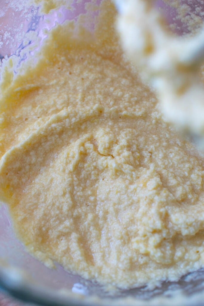 Wet ingredients to Mae pound cake mixed in an stand mixer to show the grainy texture before adding dry ingredients.