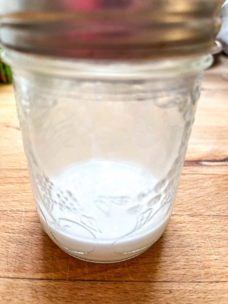 A slurry of cornstarch and water in a small jar.