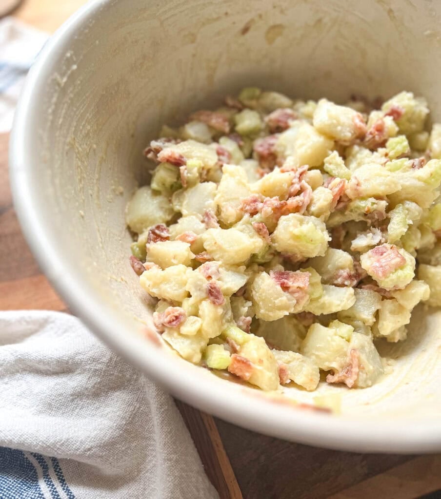 Freshly made potato bacon salad in a large ironstone bowl.