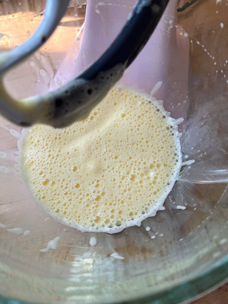 Eggs in the bowl of an electric mixer, beaten until light and slightly thickened.