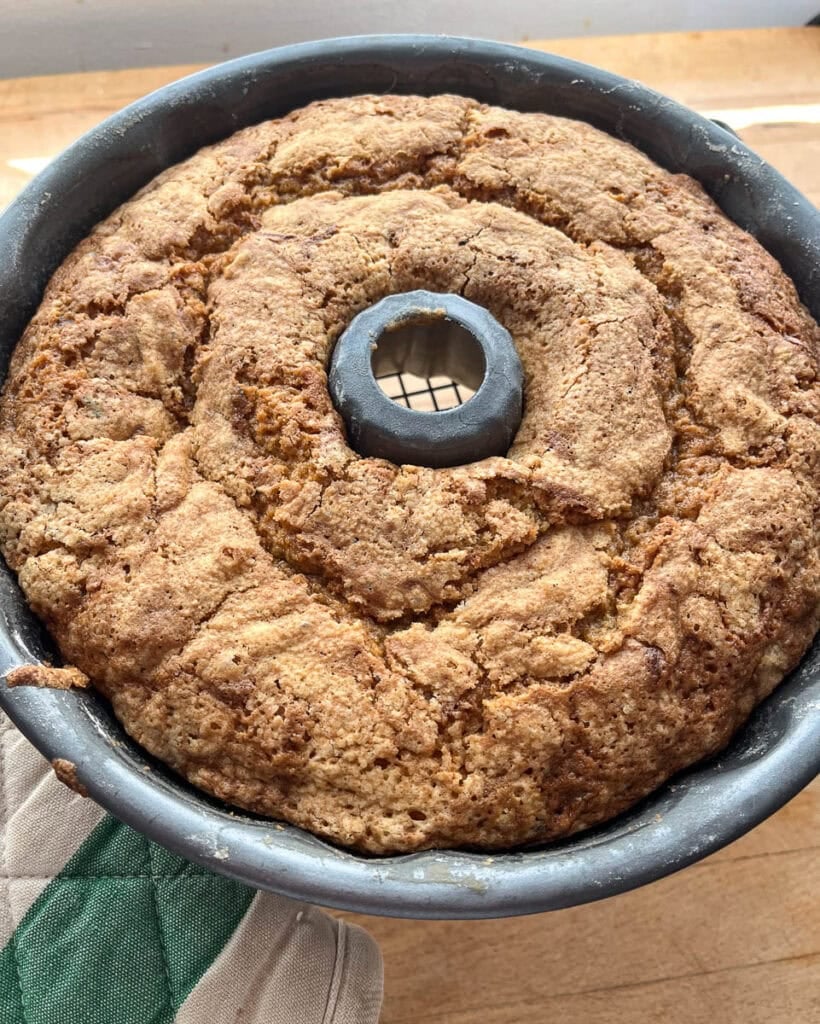 Freshly baked almond zucchini bundt cake still in the pan.