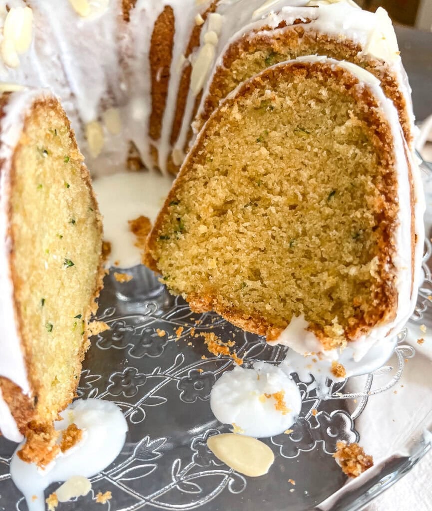 Zucchini bundt cake with a slice cut out of it.