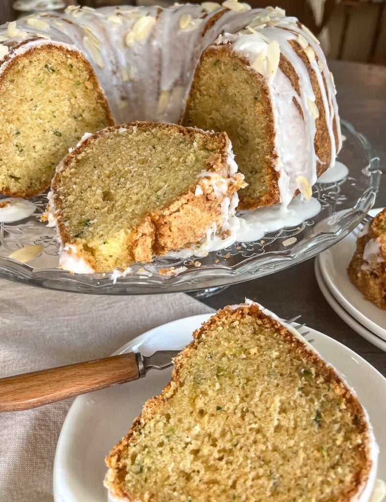 A bundt cake with a big slice cut out of it laying on its' side in the cut section.