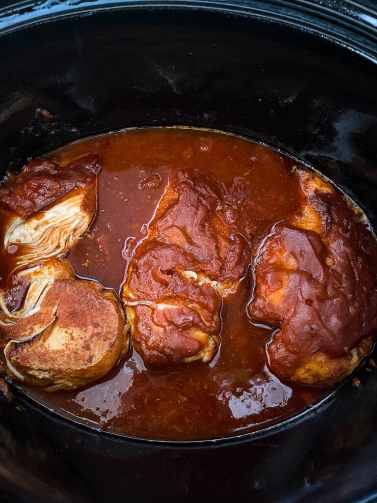 Slow cooked barbecue chicken breast still in the Crock Pot.