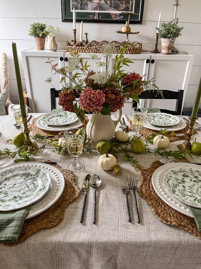 An early fall tablescape in neutral tones of cream and soft green with a centrepiece of aging hydrangea blooms and Queen Anne's Lace.
