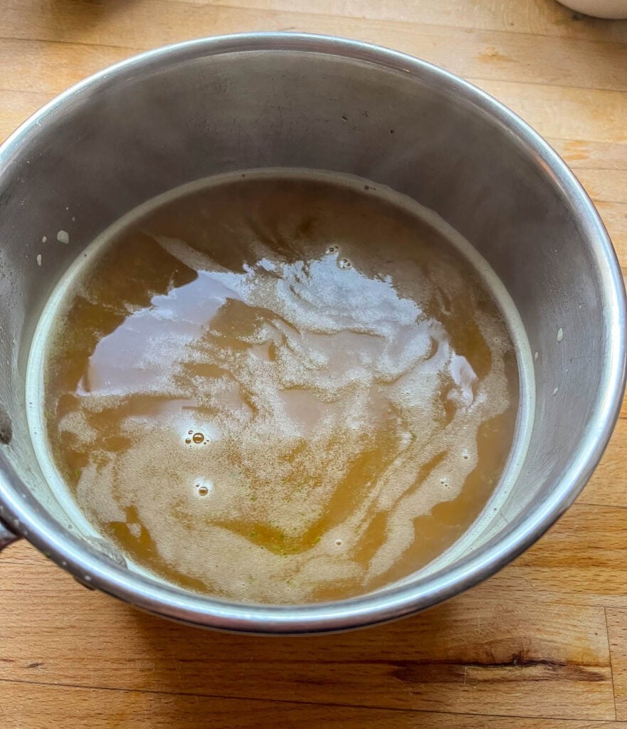 Vegetable broth and chicken bouillon cube that has been simmered on the stove top until bouillon is dissolved.