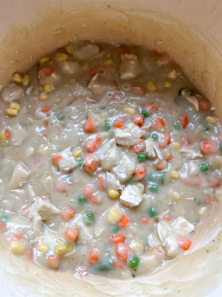 Chunks of cooked chicken breast and frozen mixed vegetables added to the thickened sauce to make chicken pot pie filling.