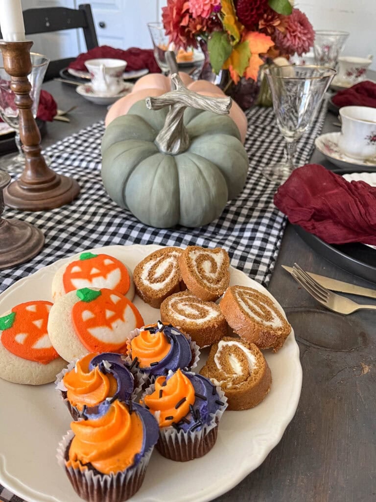 A Halloween tea party setting on a dinner table.